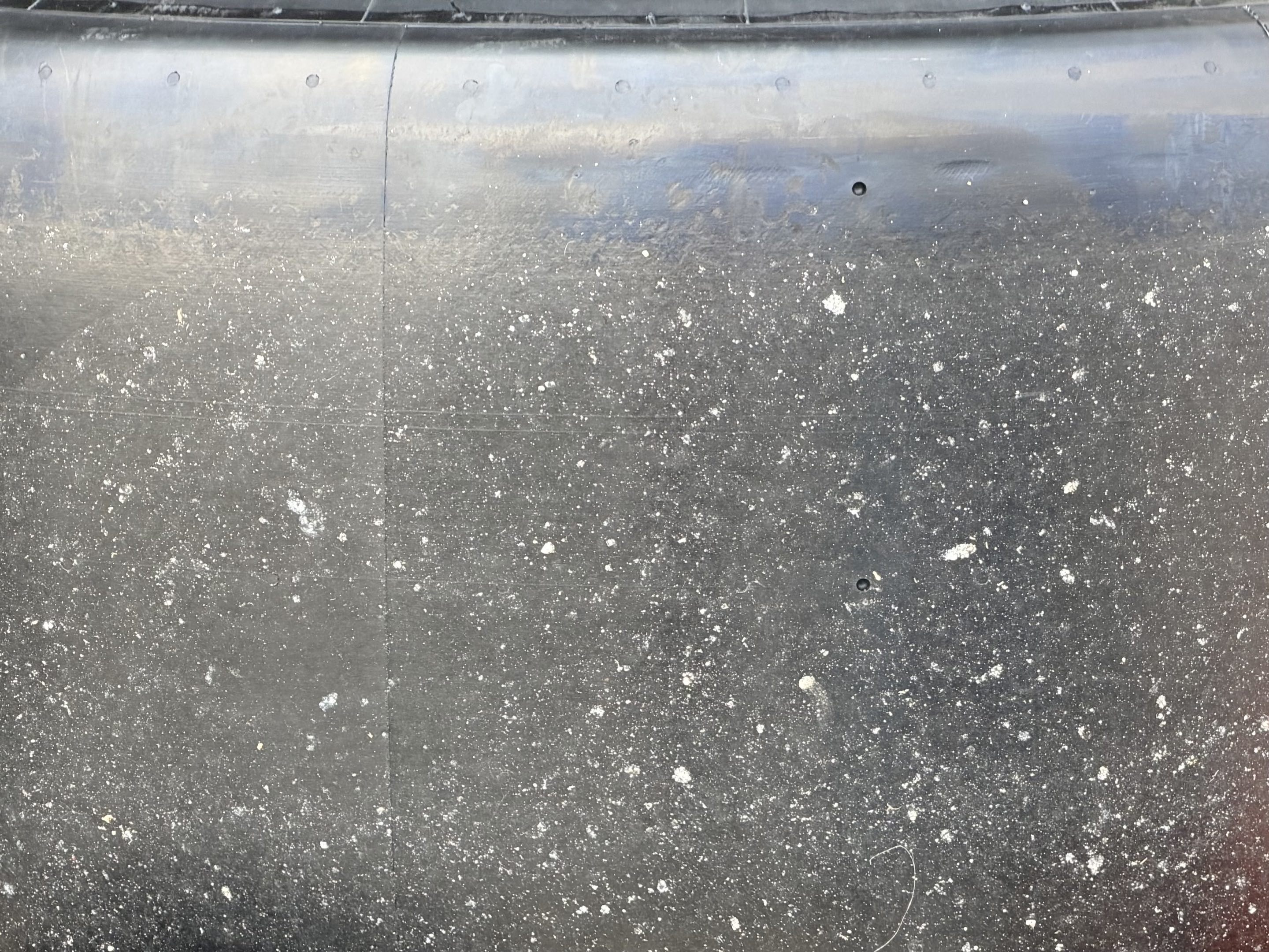 The dirty surface of a slightly used slick racing tire